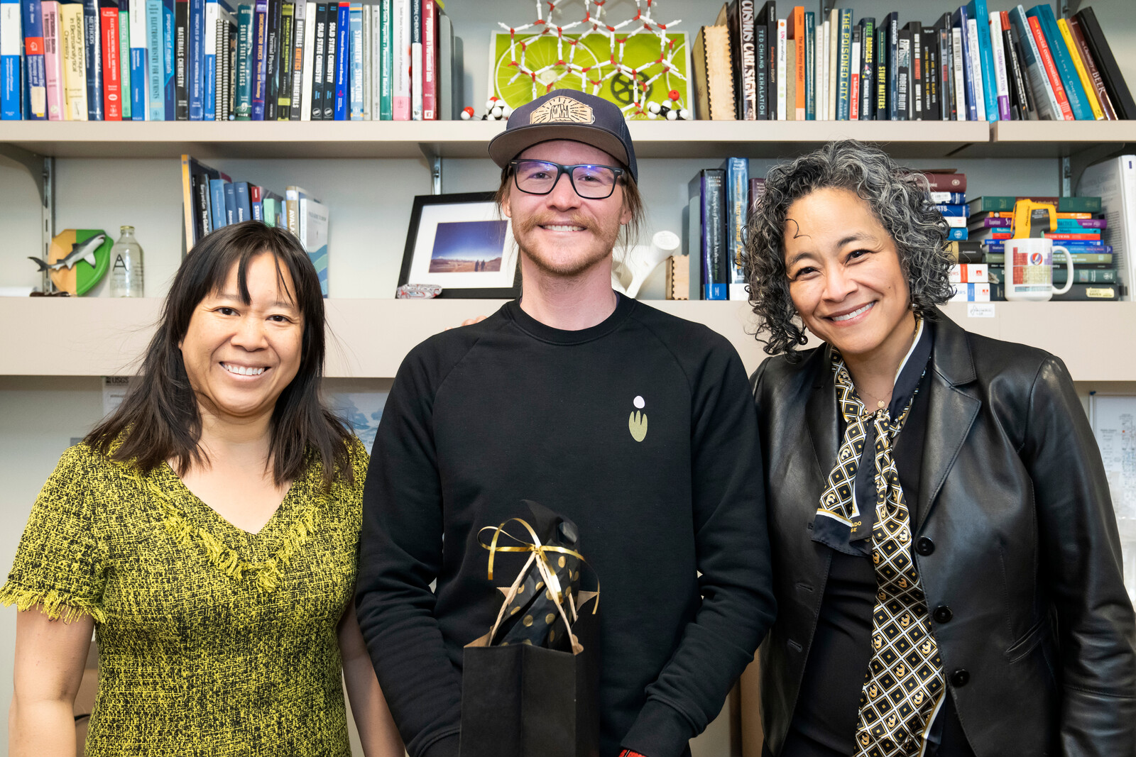 Eli Fahrenkrug, Assistant Professor of Chemistry and Biochemistry, center. Dean of Faculty Emily Chan (L) and President L. Song Richardson (R). 